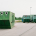 Container zur Sammlung von Altglas, Altpapier, Altkleider auf einem asphaltierten Platz am Ortsrand einer bayrischem Gemeinde